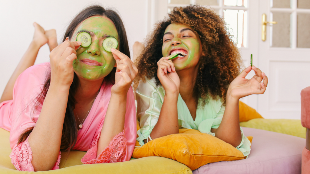 two young women wearing cucumber facemasks
